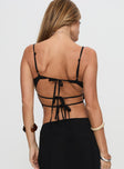 back view of model wearing Princess Polly Pappilion Top Black Sleeveless Plunger 