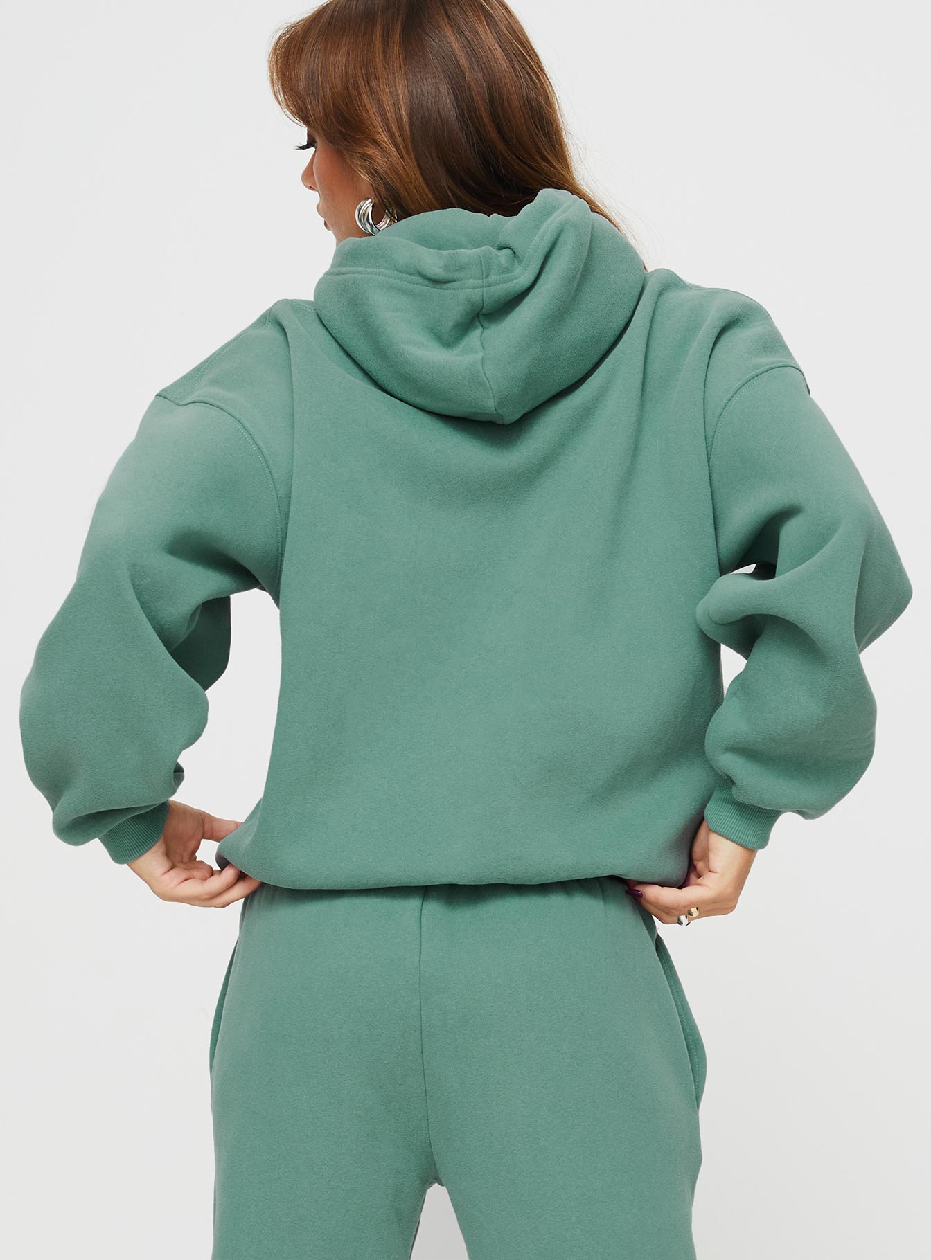 back view of model wearing Princess Polly Princess Polly Hooded Sweatshirt Bubble Text Sage / Eggshell regular 