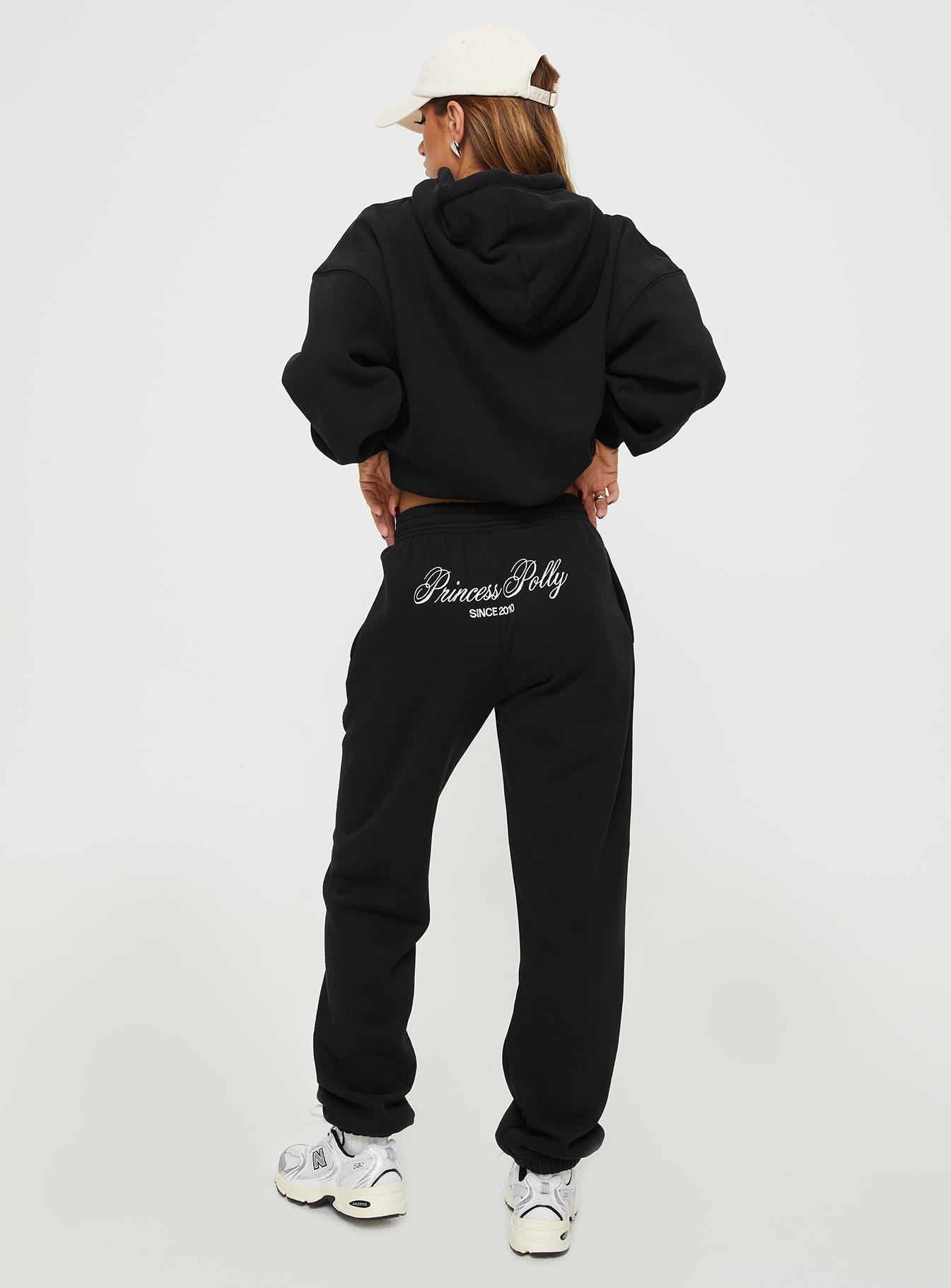 back view of model wearing Princess Polly Princess Polly Track Pants Script Black / Ivory High Waisted Pants 