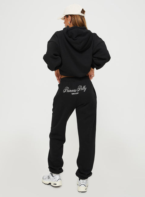 back view of model wearing Princess Polly Princess Polly Track Pants Script Black / Ivory High Waisted Pants 