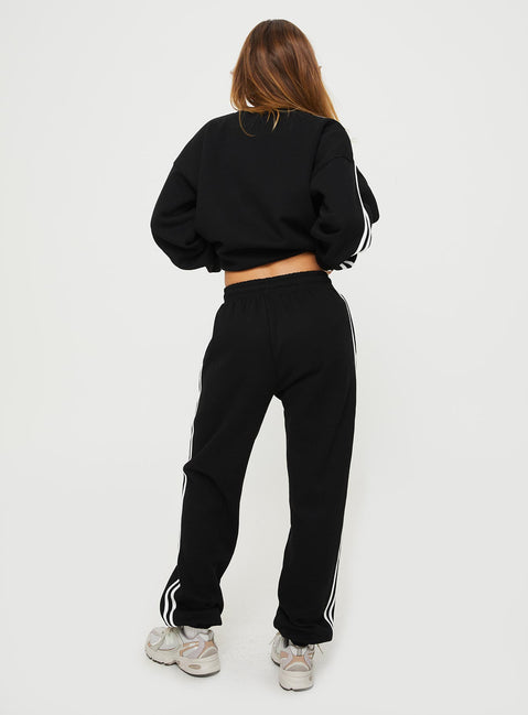 back view of model wearing Princess Polly Princess Polly Track Pants Stripe Black / White High Waisted Pants 