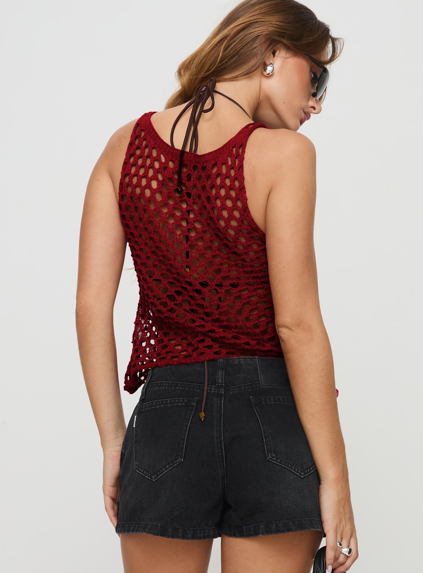 back view of model wearing Princess Polly Shikarni Knit Top Red Sleeveless Scoop Neck 