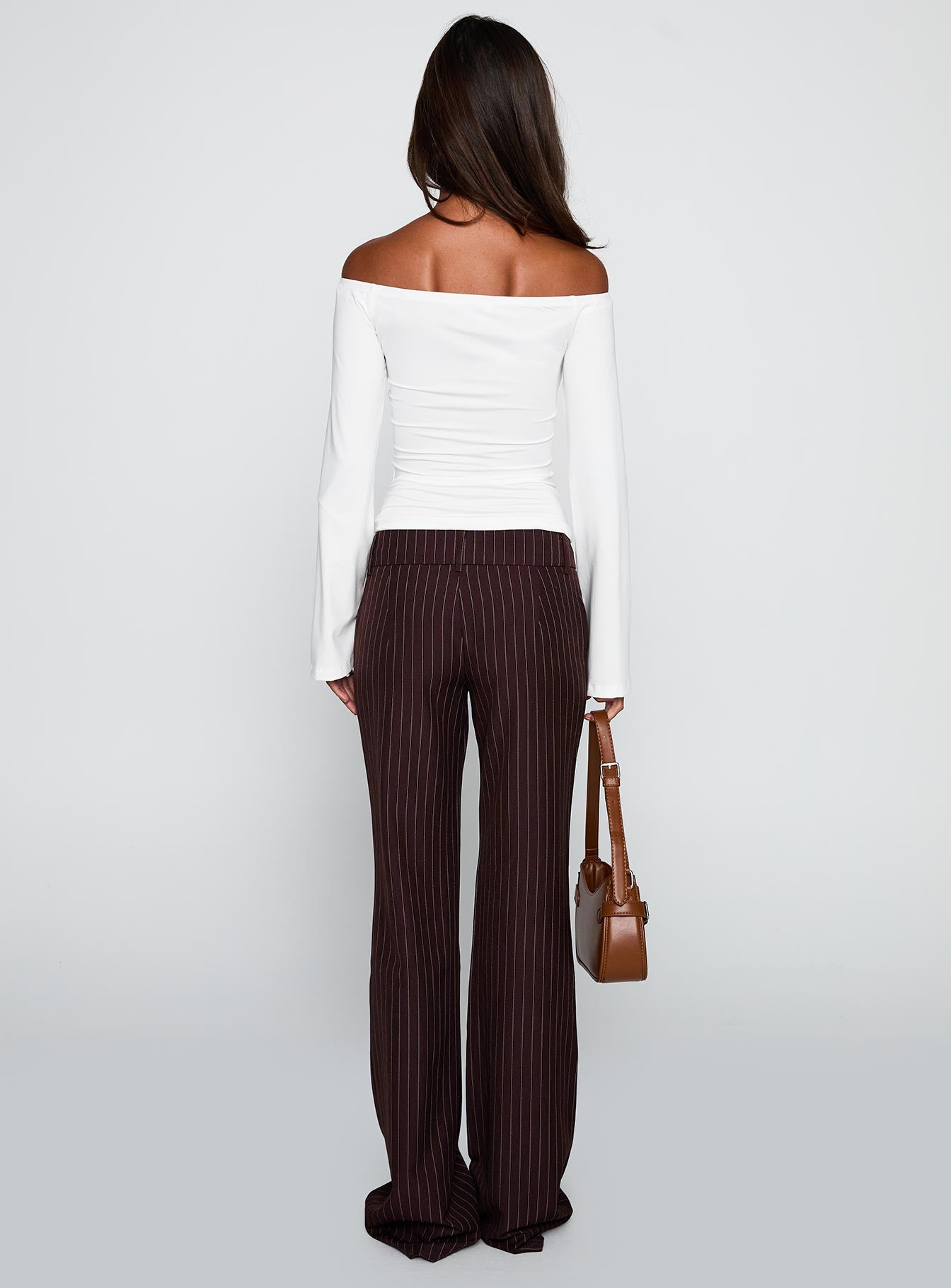 back view of model wearing Princess Polly Kinkirk Flared Pants Brown Pinstripe Low Rise Pants 