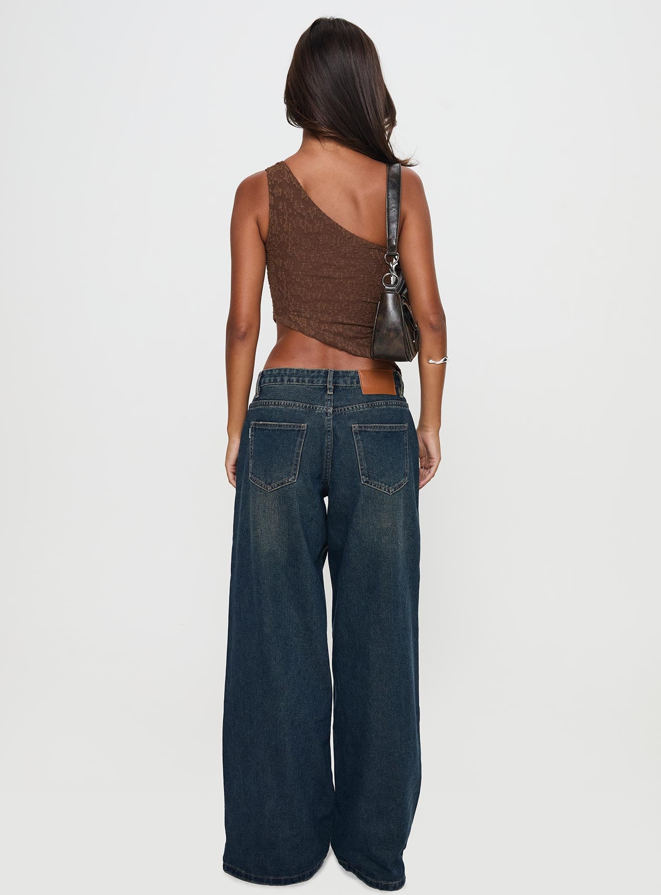 back view of model wearing Princess Polly Low Rise Wide Leg Jean Hocus Pocus Wash Low Rise Jeans 