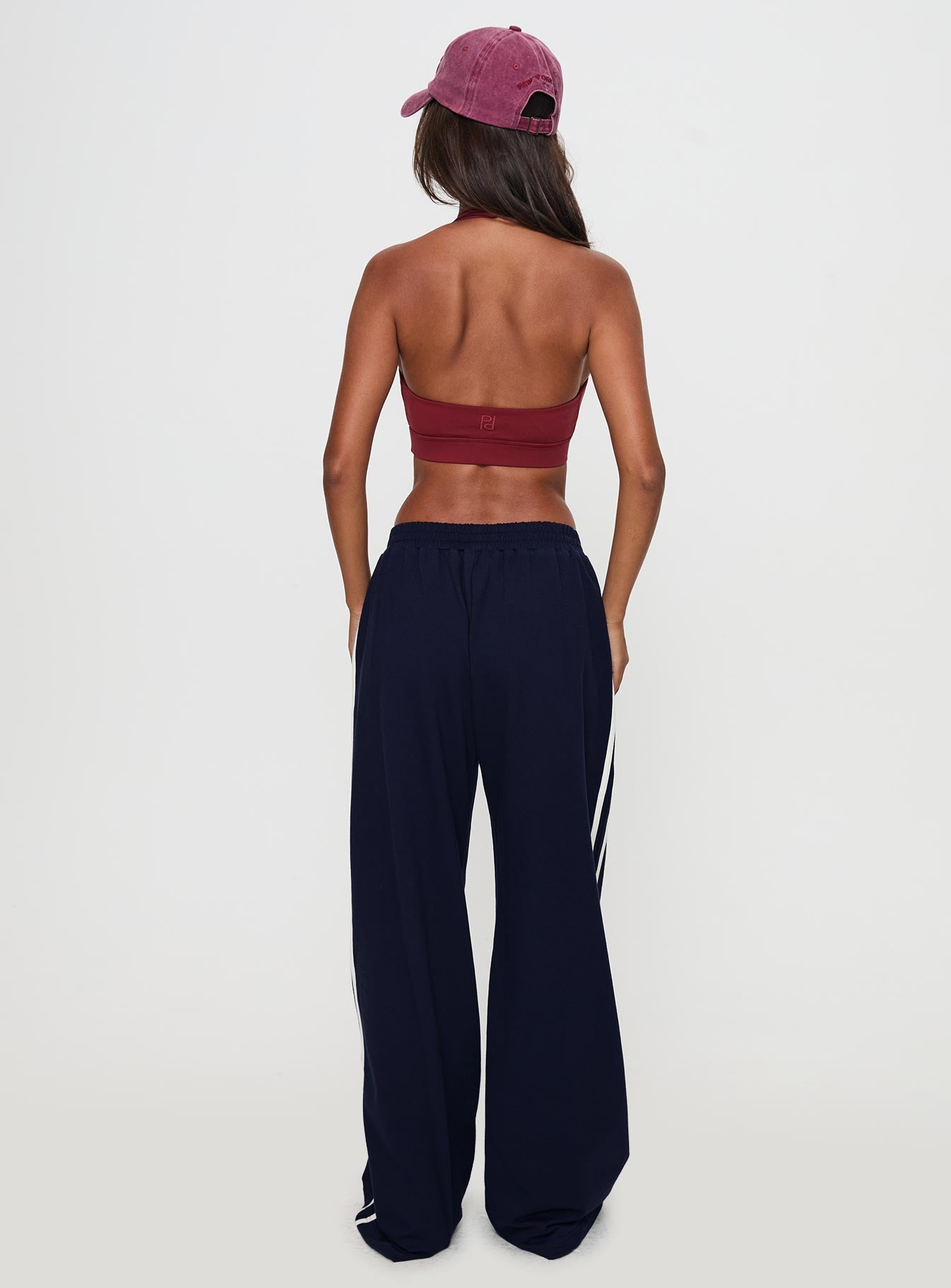 back view of model wearing Princess Polly Circuit Track Pants Navy 