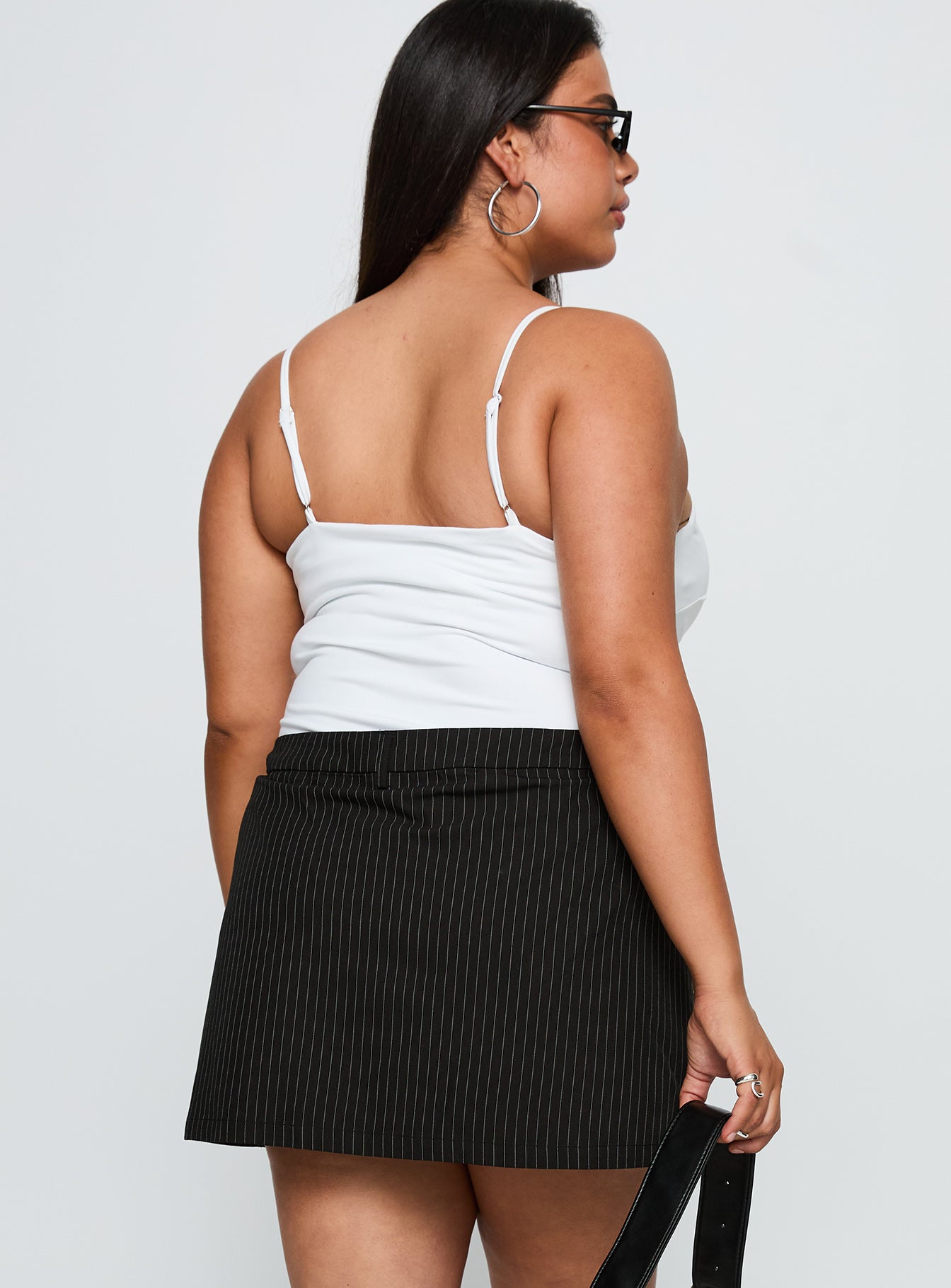 back view of model wearing Princess Polly Feminique Skort Black Stripe Curve High Waisted Shorts 