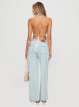 back view of model wearing Princess Polly Brayden Low Rise Relaxed Jeans Light Acid Wash Low Rise Jeans 