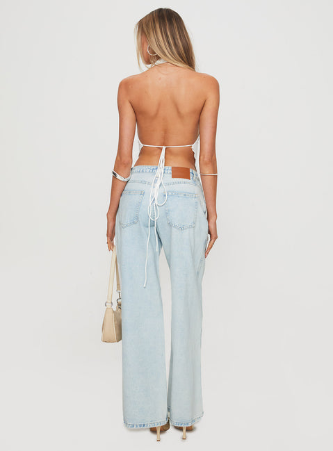 back view of model wearing Princess Polly Brayden Low Rise Relaxed Jeans Light Acid Wash Low Rise Jeans 