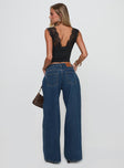 back view of model wearing Princess Polly Ramos Low Rise Denim Jeans Dark Blue Wash Low Rise Jeans 