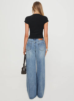 back view of model wearing Princess Polly Mellowed Out Slouchy Jeans Mid Blue High Waisted 