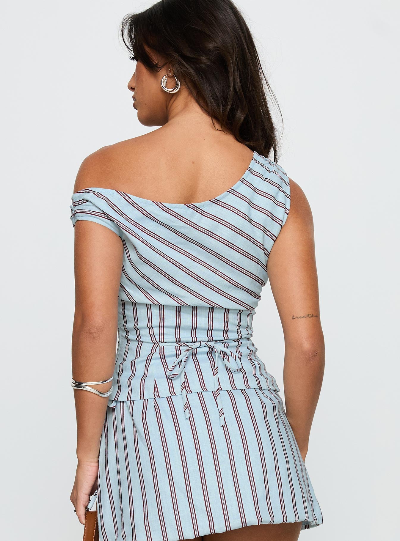 back view of model wearing Princess Polly Del Rio Off The Shoulder Top Blue / Maroon Short Sleeves Asymmetric Neckline 