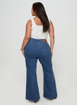 back view of model wearing Princess Polly Lucille High Rise Flare Leg Jeans Mid Wash Curve High Waisted 