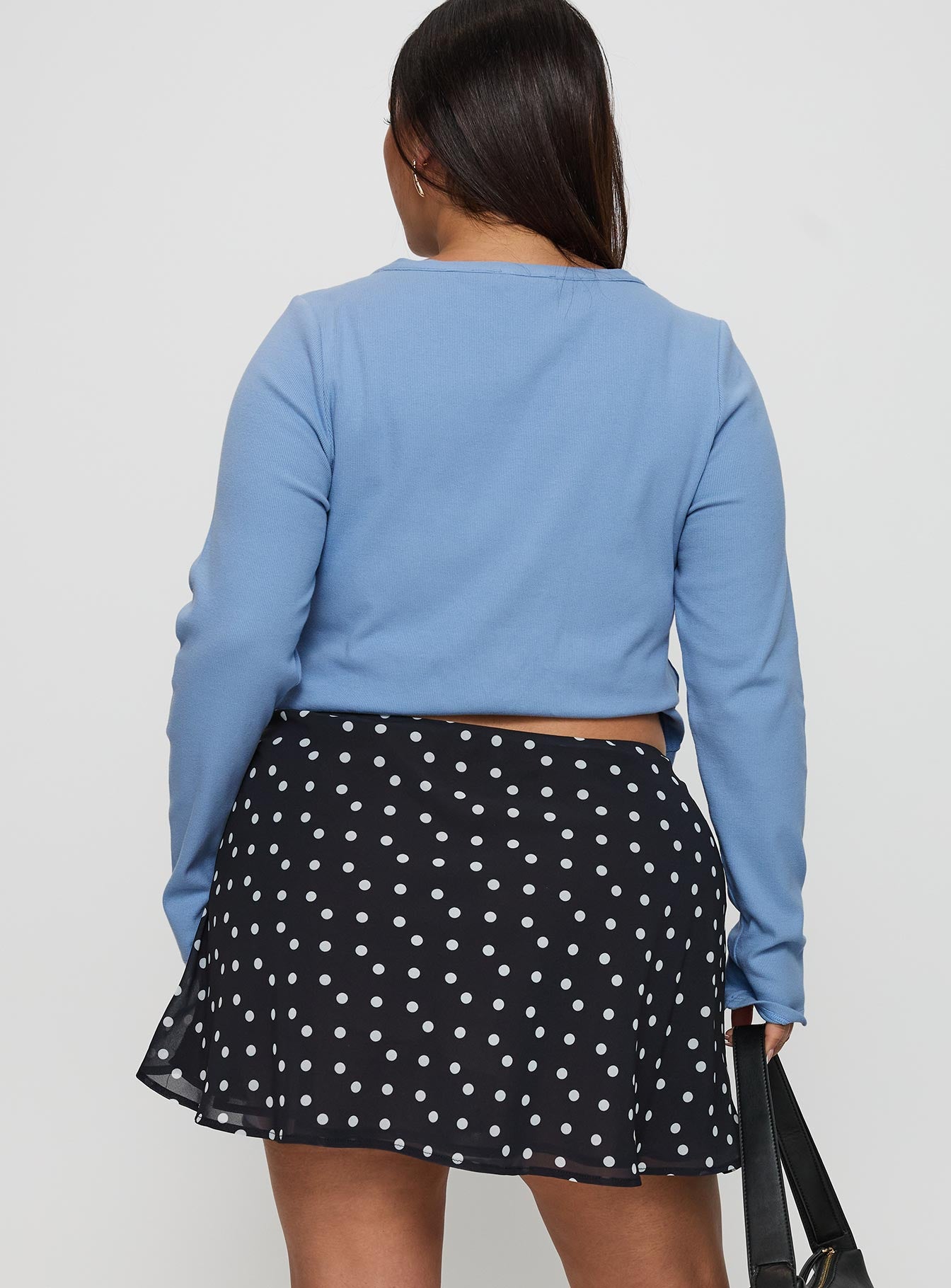back view of model wearing Princess Polly Dapple Bias Mini Skirt Black Polka Dot Curve Mini Skirts 