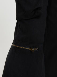 side view of model wearing Princess Polly Humphrey Cargo Pant Black Mid Rise 