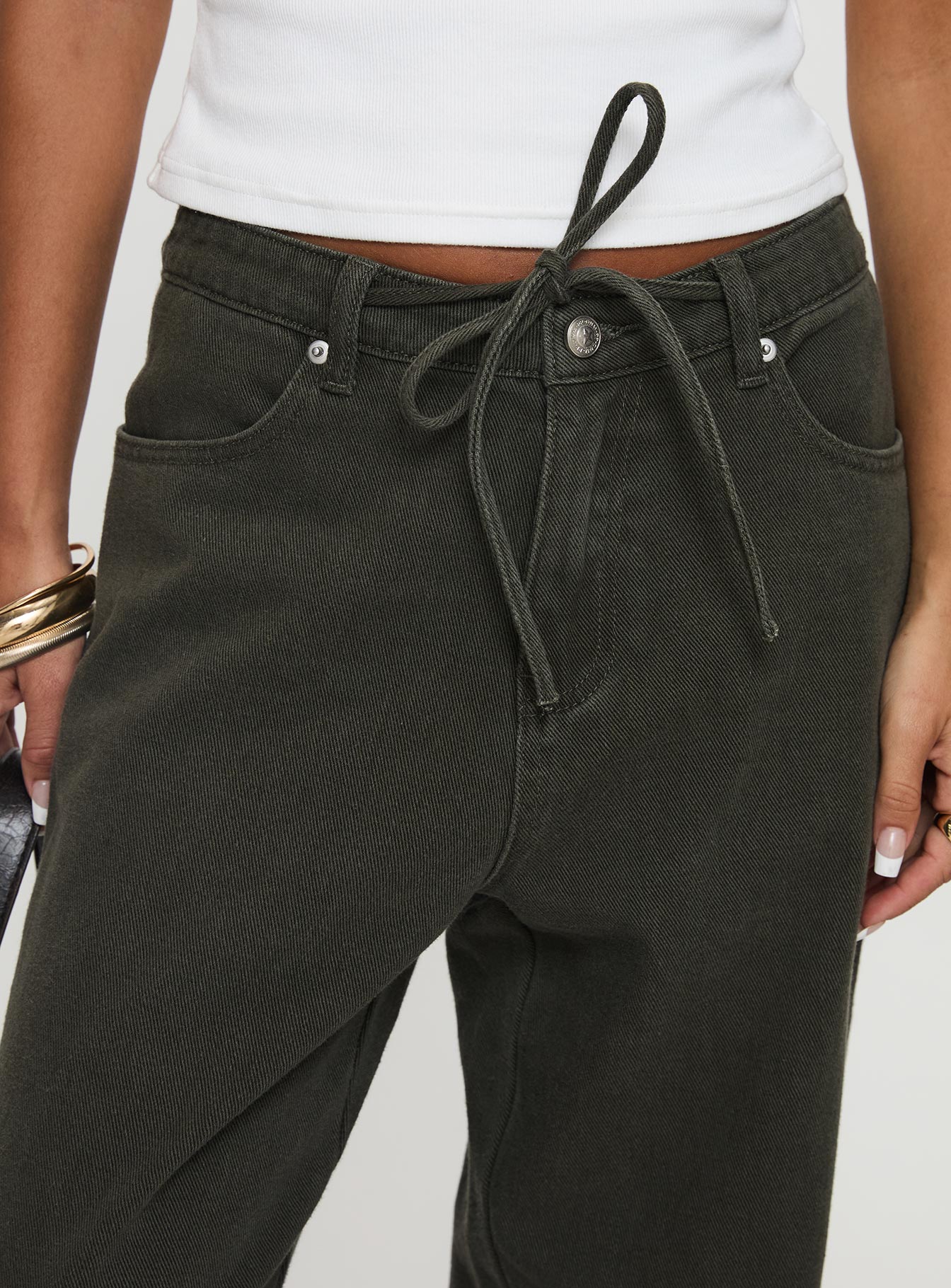 side view of model wearing Princess Polly Bruiser Tie Waist Mid Rise Wide Leg Jeans Green Petite High Rise Jeans 