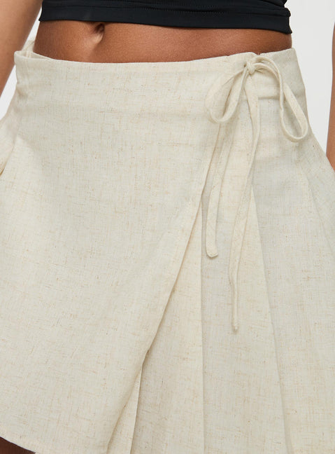 back view of model wearing Princess Polly Kippers Wrap Mini Skirt Oat Mini Skirts 
