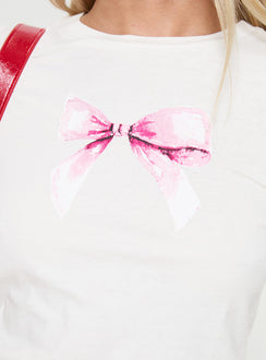 side view of model wearing Princess Polly Bow Baby Long Sleeve Top White Full Sleeves Full Sleeves Crew Neck Crew Neck 