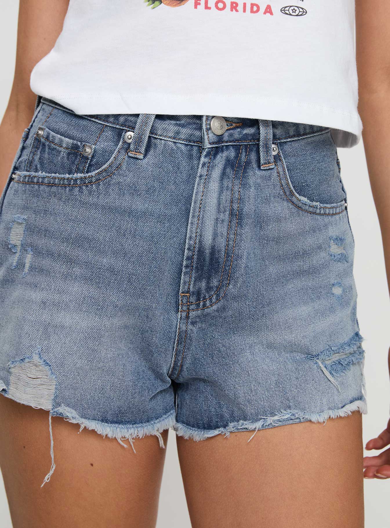 back view of model wearing Princess Polly Gratzi Mid Rise Denim Shorts Blue High Waisted Shorts 