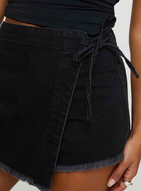 side view of model wearing Princess Polly Bowden Skort Washed Black High Waisted Shorts 