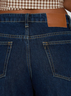 back view of model wearing Princess Polly Darla Low Rise Straight Leg Cuff Jean Dark Blue Wash Low Rise Jeans 