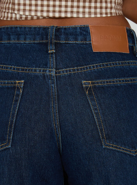 back view of model wearing Princess Polly Darla Low Rise Straight Leg Cuff Jean Dark Blue Wash Low Rise Jeans 