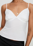 Front view of model wearing  front Princess Polly Sleeveless Plunger  Aruba Embroidered Cami White