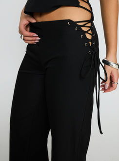 back view of model wearing Princess Polly Riane Lace Up Pants Black Mid Rise Pants 