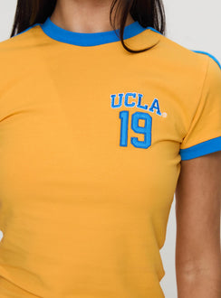 back view of model wearing Princess Polly UCLA Goalie Baby Tee Yellow Short Sleeves Crew Neck 
