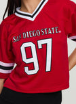 back view of model wearing Princess Polly SDSU Football Jersey Red Half Sleeves V-Neck 