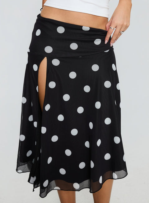   side view of model wearing Princess Polly Dulciana High Split Asymmetrical Midi Skirt Black / Polka Dot Midi Skirts 