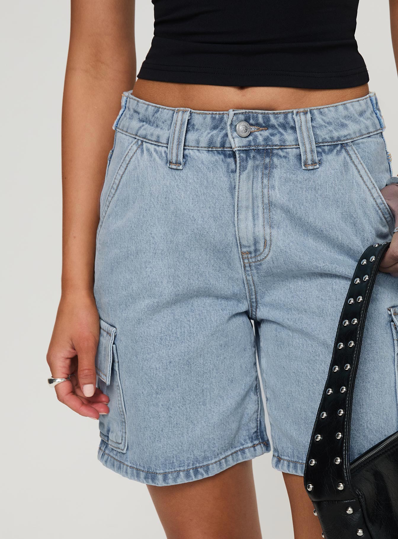 back view of model wearing Princess Polly Mika Carpenter Denim Shorts Light Wash High Waisted Shorts 