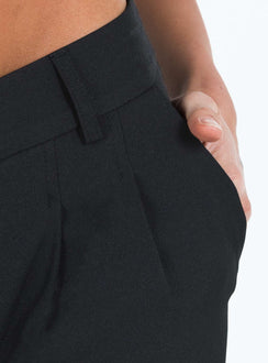 back view of model wearing Princess Polly Archie Low Rise Pants Black Petite Mid Rise 