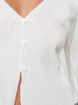 Cream Long sleeve top Plisse material, v neckline, flared sleeves, button fastening at front, split hem