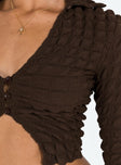 Brown long sleeve top Popcorn puff material  Classic collar  V neckline  Button front fastening 