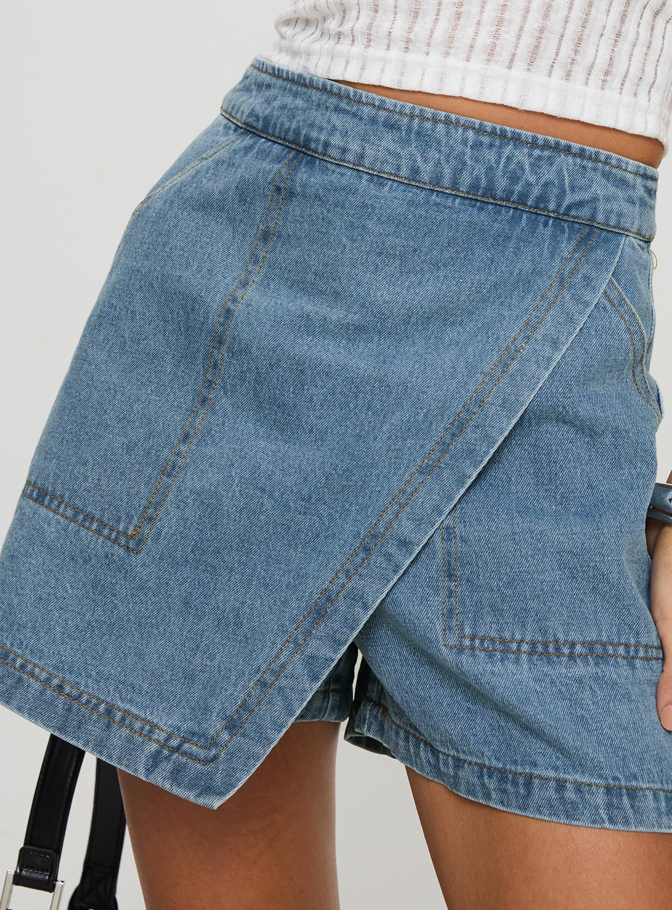 side view of model wearing Princess Polly Bentiez Denim Skort Mid Wash High Waisted Shorts 