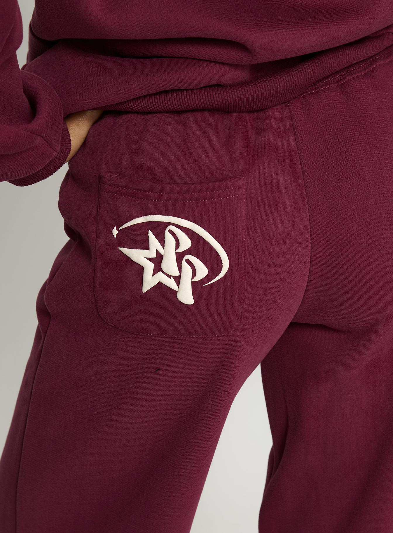 back view of model wearing Princess Polly Princess Polly Stargirl Wide Leg Sweat Pants Burgundy High Rise Pants 