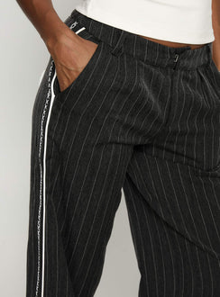side view of model wearing Princess Polly Knowla Pleated Trouser Pant Grey Pinstripe Mid Rise Pants 