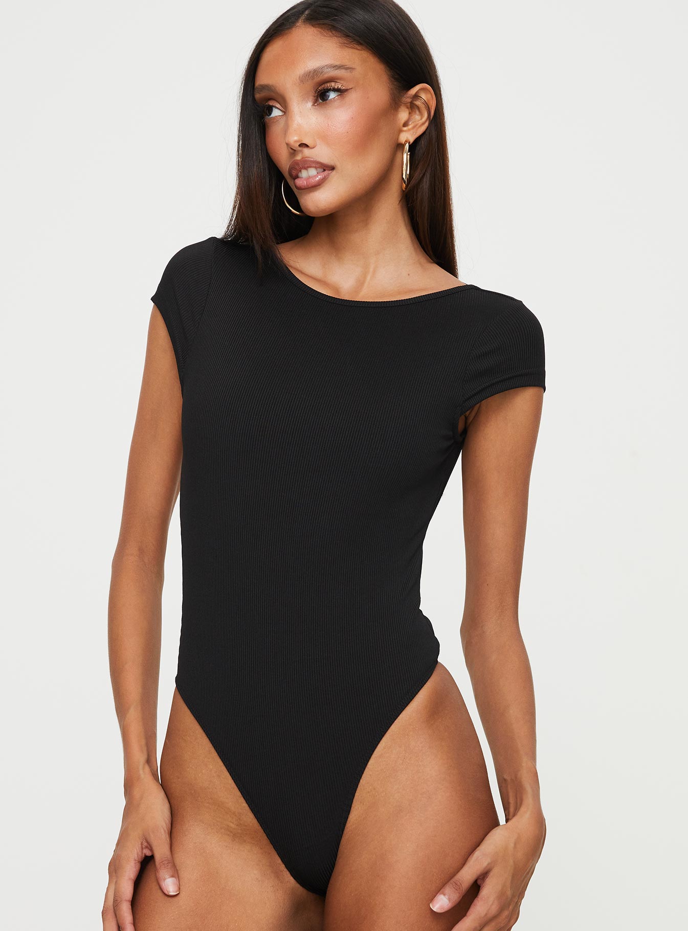 side view of model wearing Princess Polly Solita Bodysuit Black Short Sleeves Crew Neck 
