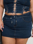 back view of model wearing Princess Polly Popular Low Rise Mini Skirt Mid Blue Wash Curve Mini Skirts 