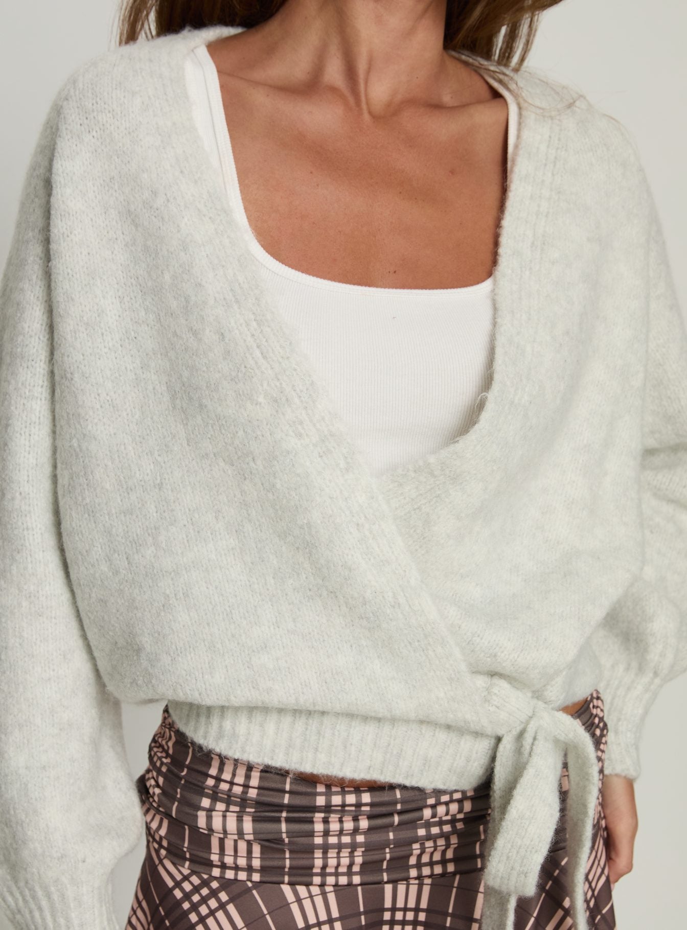 back view of model wearing Princess Polly Daelan Wrap Knit Cardigan Grey Marle cropped 