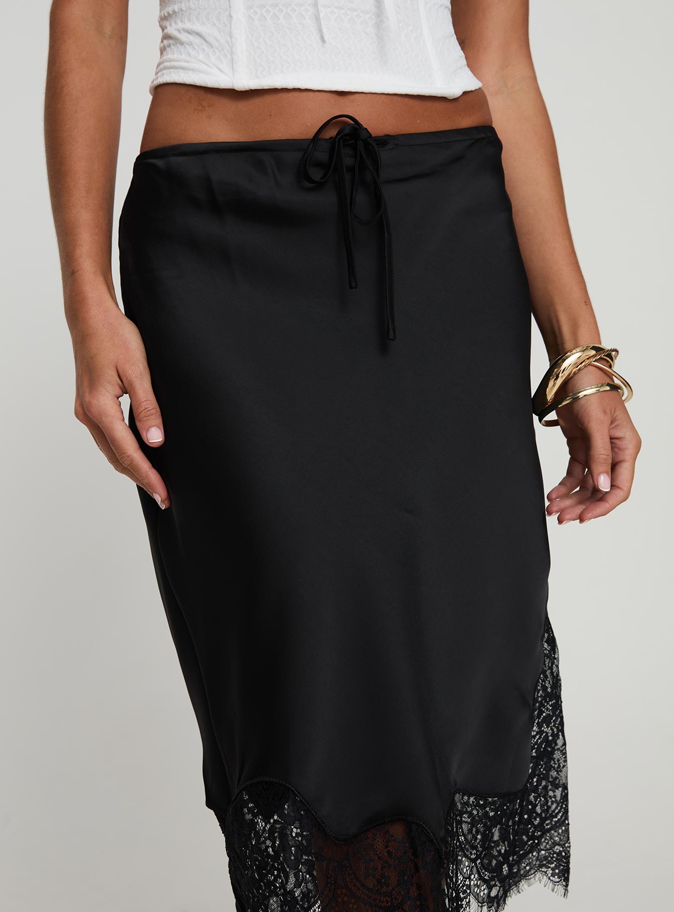 back view of model wearing Princess Polly Gervais Satin Midi Skirt Black Midi Skirts 