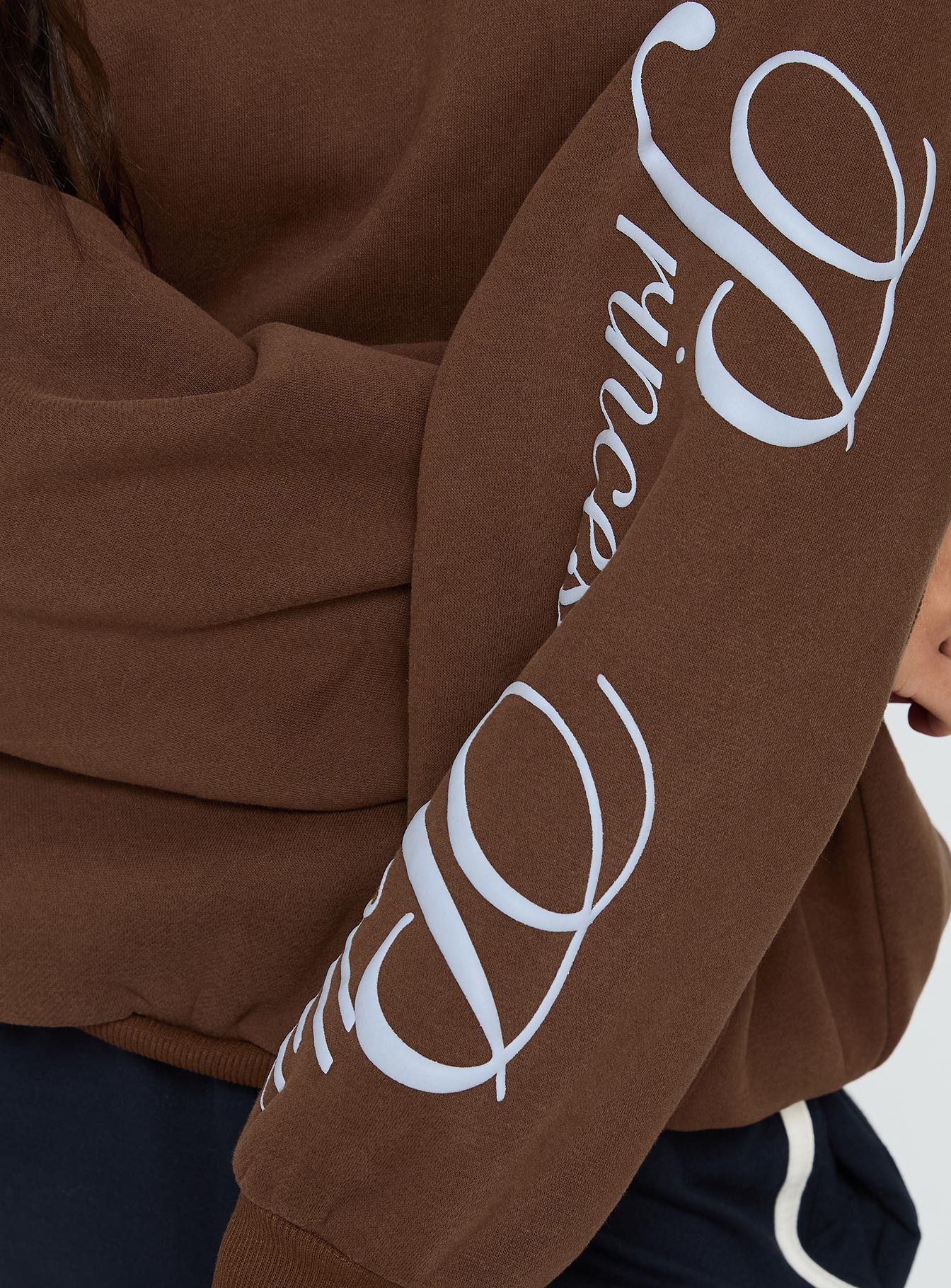 side view of model wearing Princess Polly Princess Polly Script Text Graphic Hoodie Brown / Blue Long 