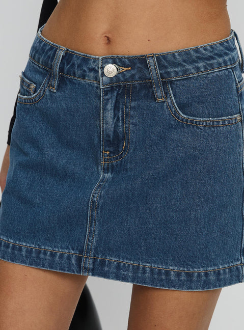   side view of model wearing Princess Polly Nickei Denim Mini Skirt Mid Wash Tall Mini Skirts 