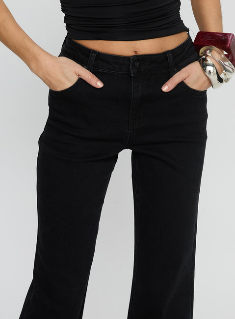 back view of model wearing Princess Polly Magic Mirror Mid Rise Bootleg Jeans Washed Black Mid Rise Jeans 