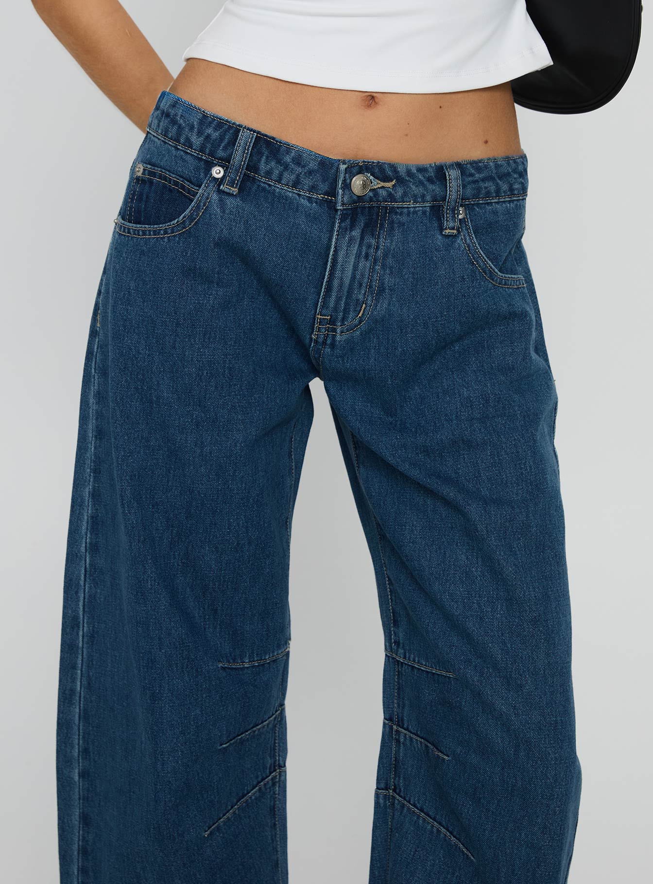 side view of model wearing Princess Polly Lost Track Mid Rise Barrel Leg Jeans Mid Wash Mid Rise Jeans 