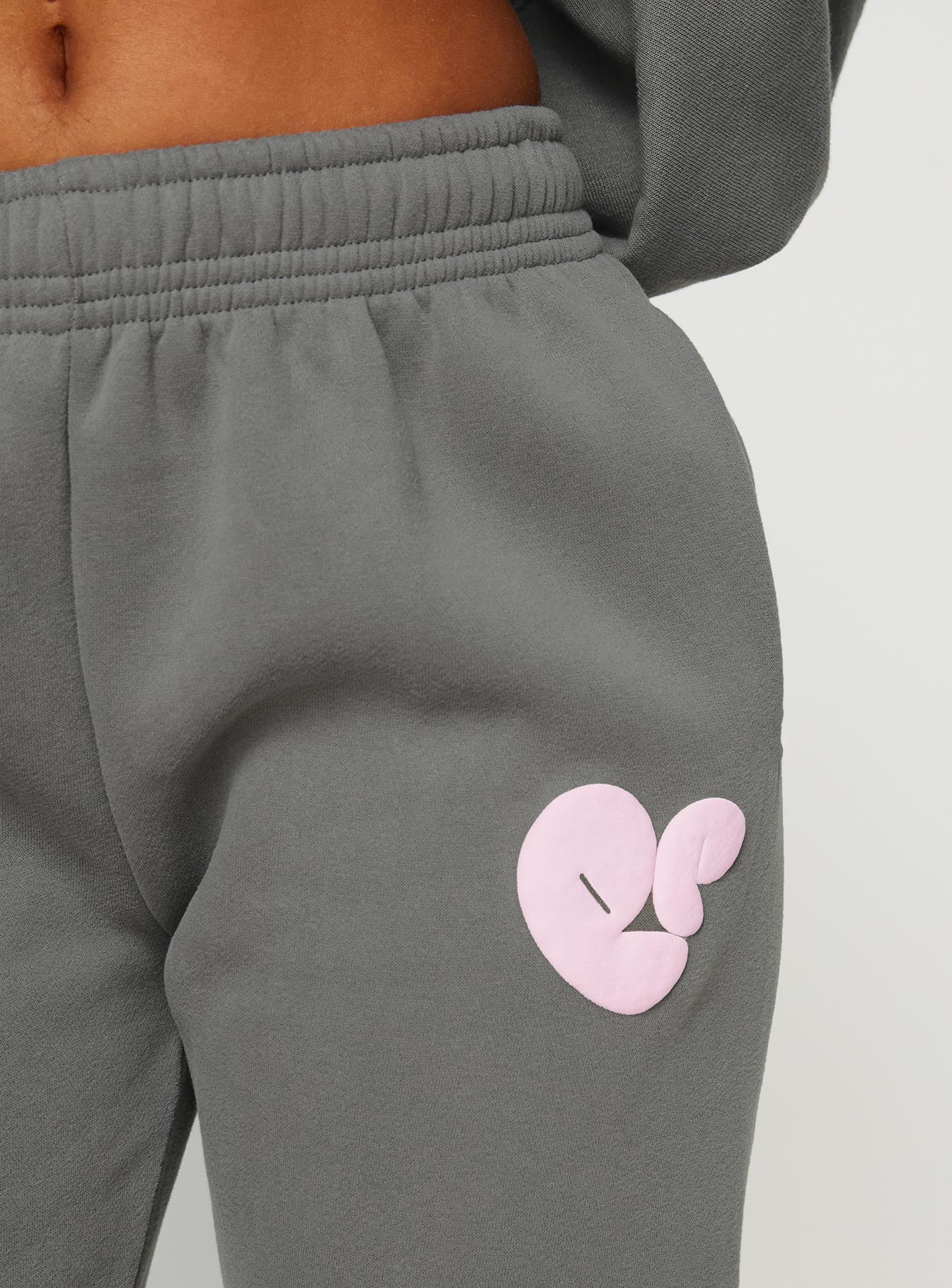 front view of model wearing Princess Polly Princess Polly Track Pants Bubble Text Charcoal / Light Pink Mid Rise 