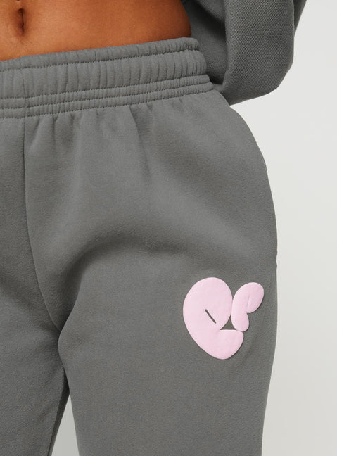 front view of model wearing Princess Polly Princess Polly Track Pants Bubble Text Charcoal / Light Pink Mid Rise 