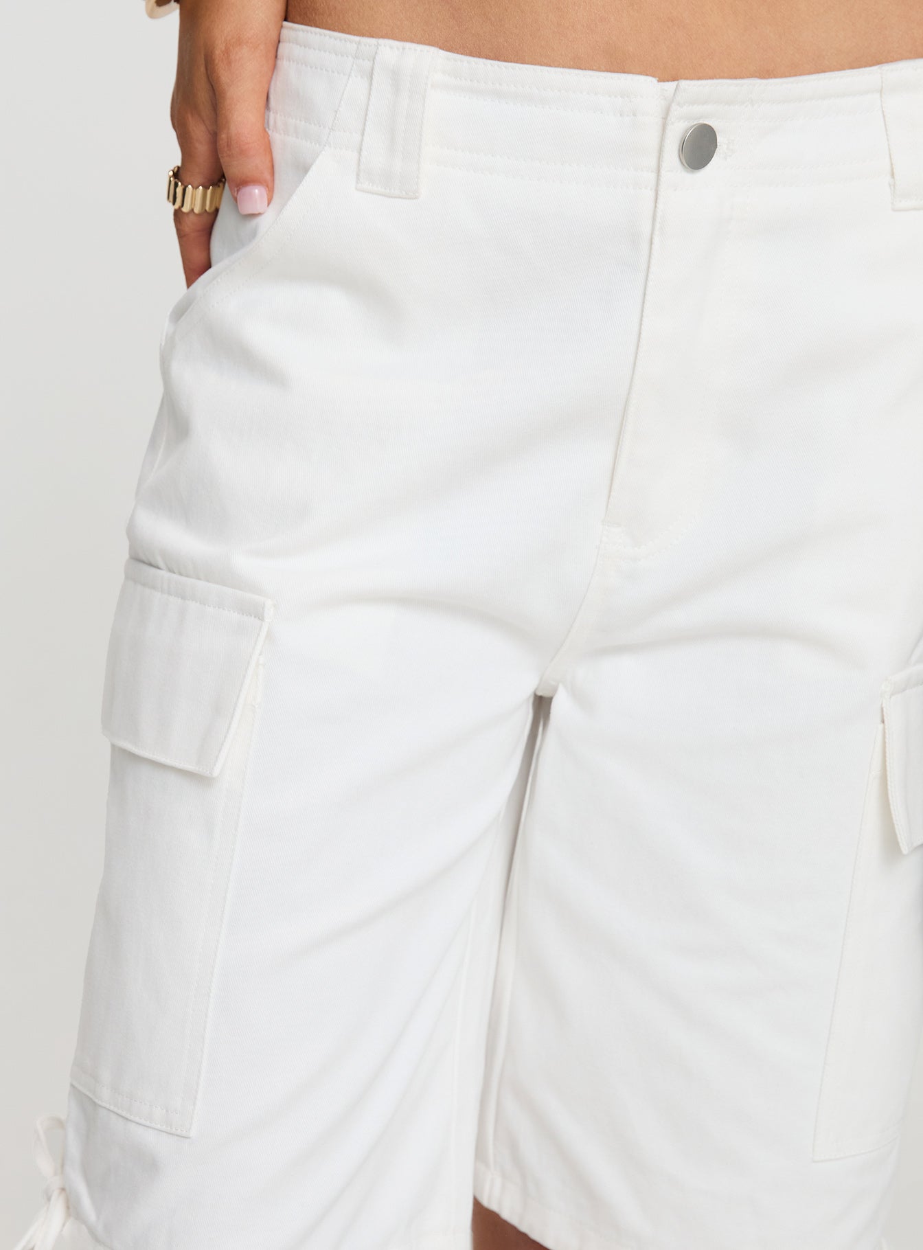 side view of model wearing Princess Polly Bleachers Shorts White High Waisted Shorts 