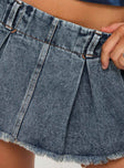 Faded blue denim Low rise mini skort Belt looped waist, zip fastening at side, pleated design, built-in shorts