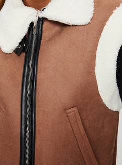 Shearling vest  Classic collar, twin hip pockets, shearling detail at shoulder and hem, faux leather detail and strap fastening at neck, silver-toned hardware, zip fastening at front 